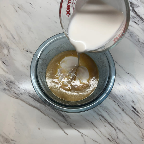 adding the coconut milk to the bowl