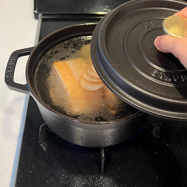 covering the broth with a lid